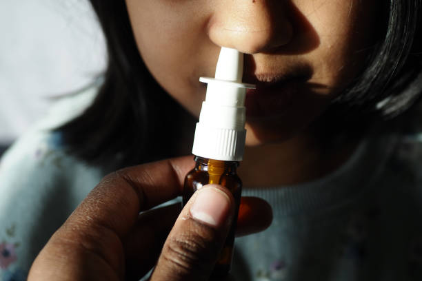 istock close up of sick child using nasal medicine spray 1521200557