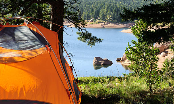 Camping Tent by Mountain Lake stock photo