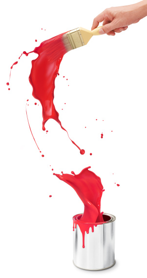 hand holding paintbrush creating red paint splash from its bucket