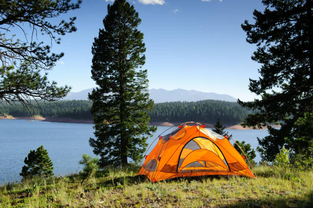 Camping Tent by Mountain Lake stock photo