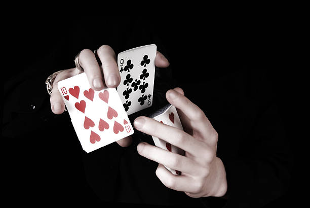 Young magicians hands holding a lot of play cards stock photo