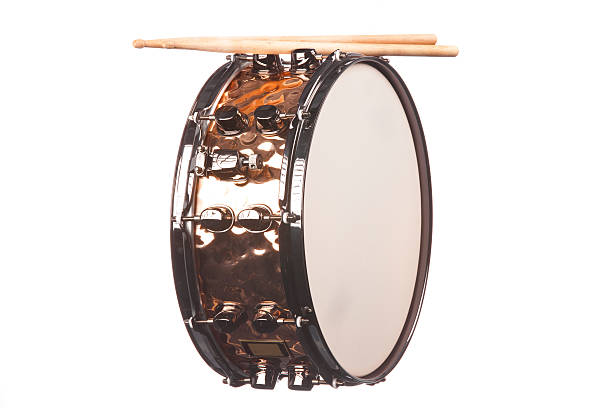 Snare Drum Isolated on White A copper snare drum with sticks isolated against a white background in the horizontal format. snare drum stock pictures, royalty-free photos & images