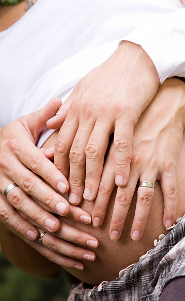 istock Father and mother's hands on pregnant woman's belly 152121206