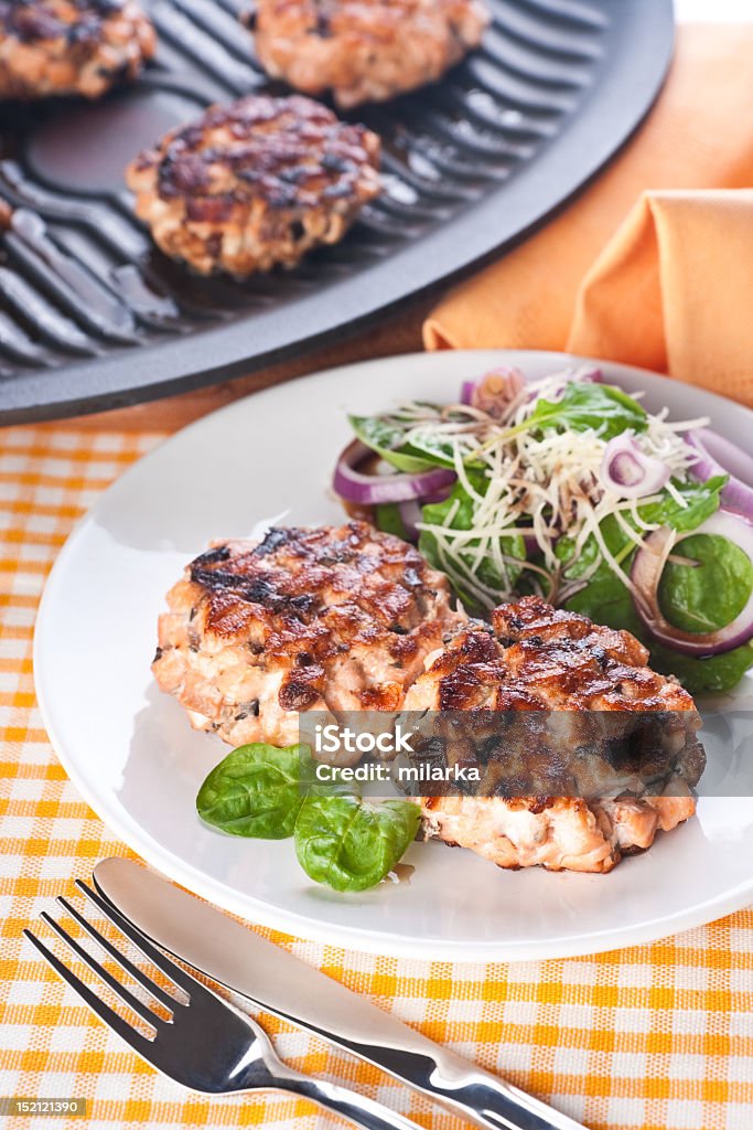 Salmon cutlet with a salad of spinach and onion Salmon cutlet with a salad of spinach, onion and cheese Balsamic Vinegar Stock Photo