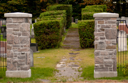 Two stone pillars at an entrance to old cemetery