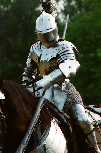 Jousting knight in authentic 16th century armor, mounted and ready for battle. Scanned from film: visible film grain.
