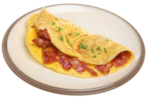 Freshly cooked bacon omelet isolated on white.