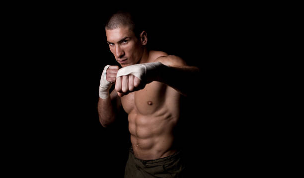 Image of young man boxing into camera stock photo