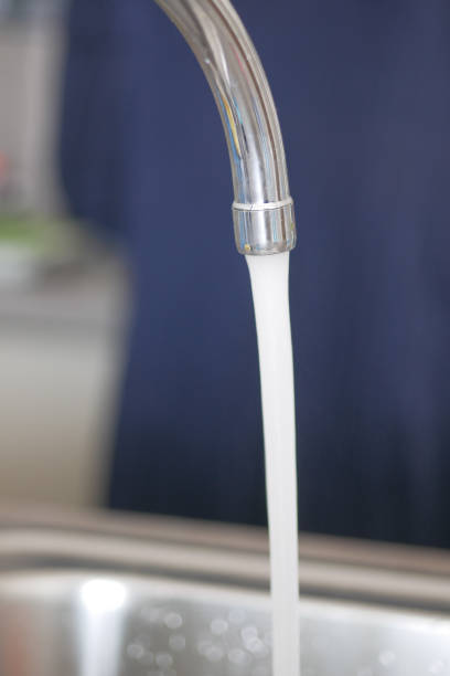 istock Water dripping from faucet tap at kitchen. Closeup 1521229669