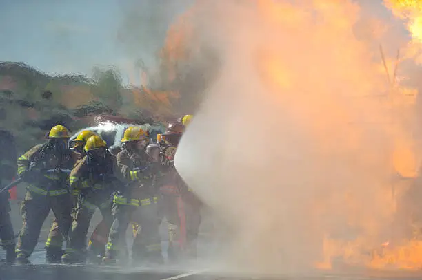 Firefighters attack a propane fire during a training exercise.