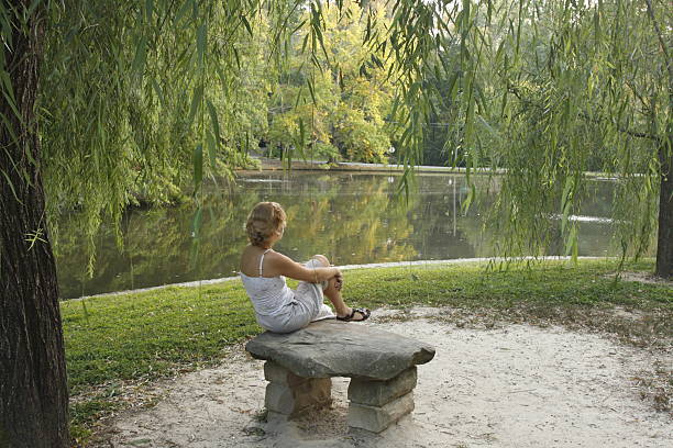 young lady in a park stock photo