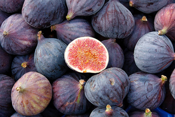 Heap of tasty organic figs at local farmers market Tasty organic figs at local market fig photos stock pictures, royalty-free photos & images