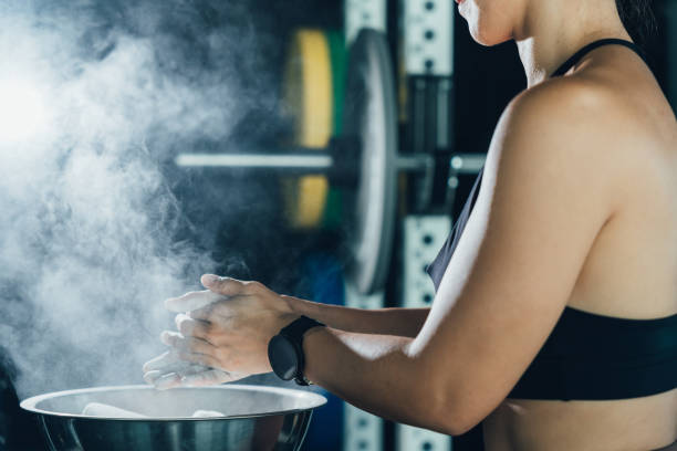 istock Asian girl exercising Hands beating the dough before lifting weights, lights and smoke 1521245567