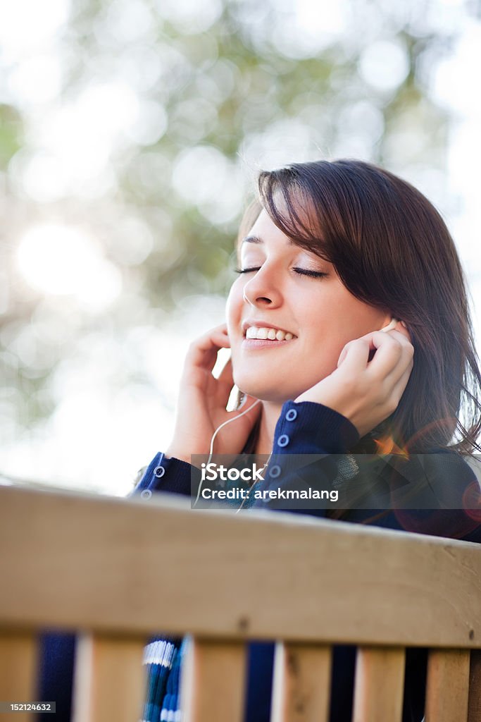 Mixed race college student listening to music A portrait of a mixed race college student listening to music at campus 20-29 Years Stock Photo