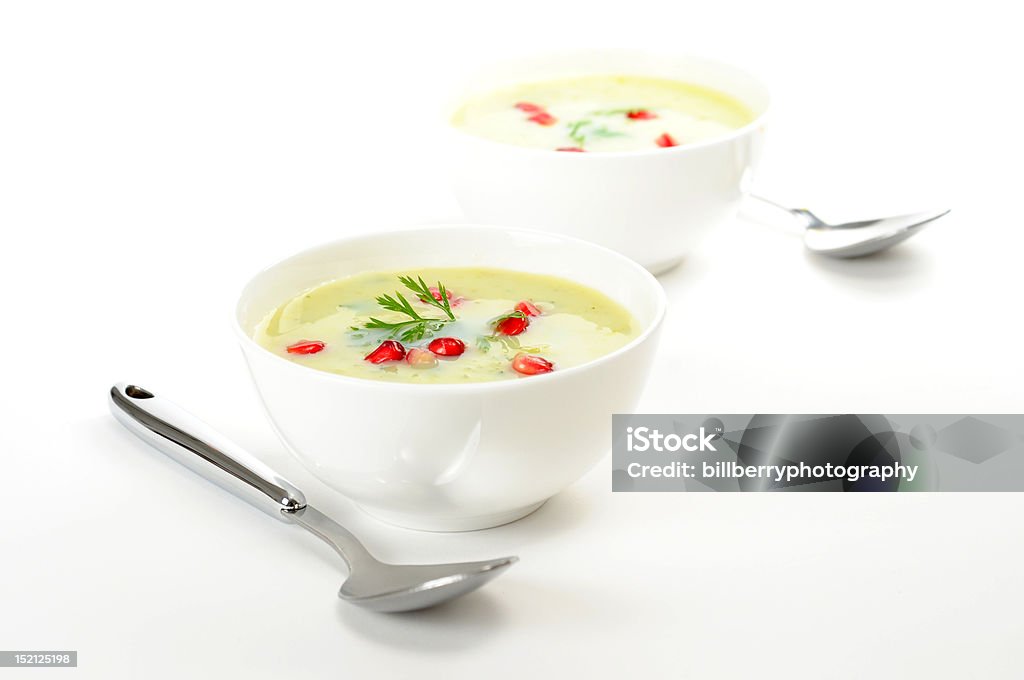 Broccoli and Pomegranate Soup Bowls of health broccoli soup garnished with pomegranate. Bowl Stock Photo