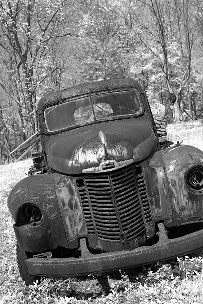 istock Old Rusty Truck Wooded Field Black and White 152125225