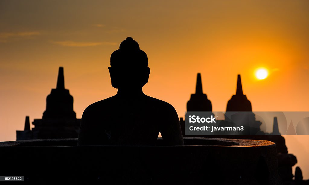 A silhouette of the Borobudur Temple at sunrise in Indonesia Borobudur temple at sunrise, Java, Indonesia Ancient Stock Photo