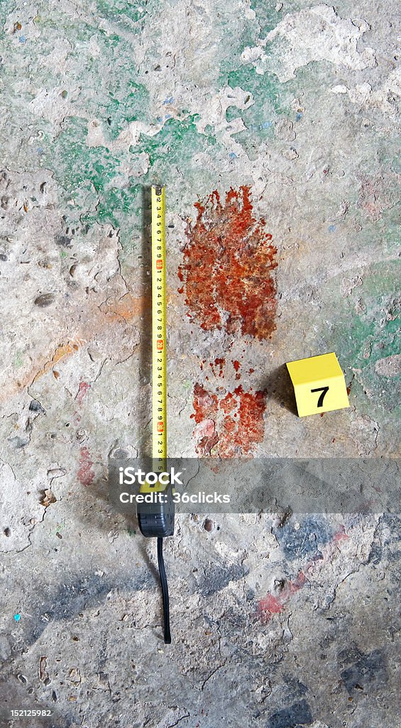 Bloody Footprint Crime scene photo of a Bloody footprint, with a measuring tape and evidence placard next to it Blood Stock Photo