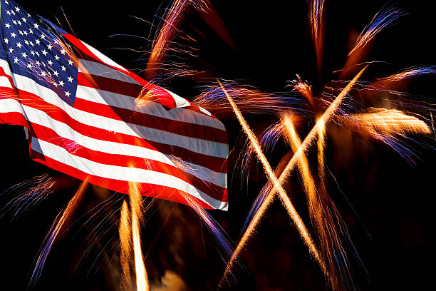 istock USA flag against backdrop of light streams of fireworks 152126433