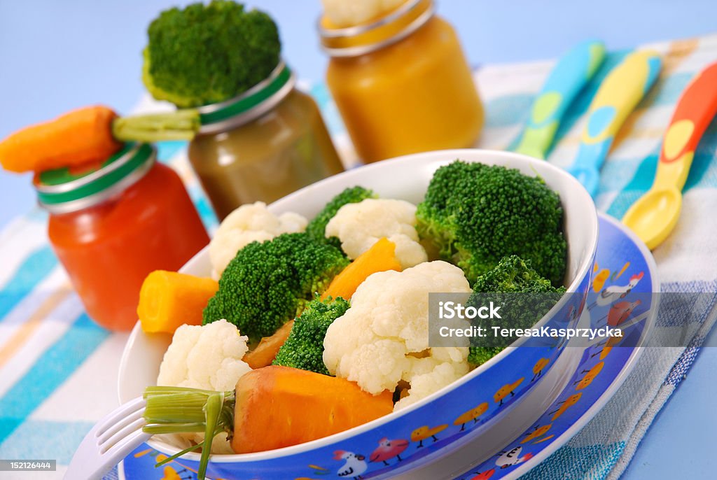 steamed vegetables for baby steamed broccoli,carrot and cauliflower  for baby or ready vegetables in jars Baby Food Stock Photo