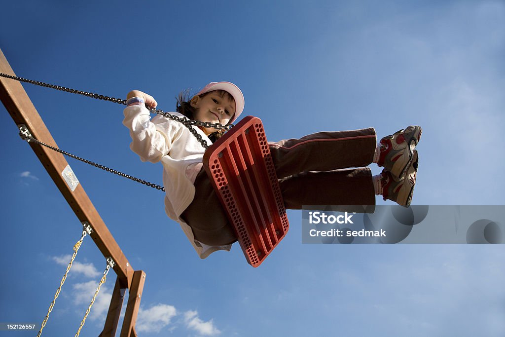 little girl on the seesaw Child Stock Photo