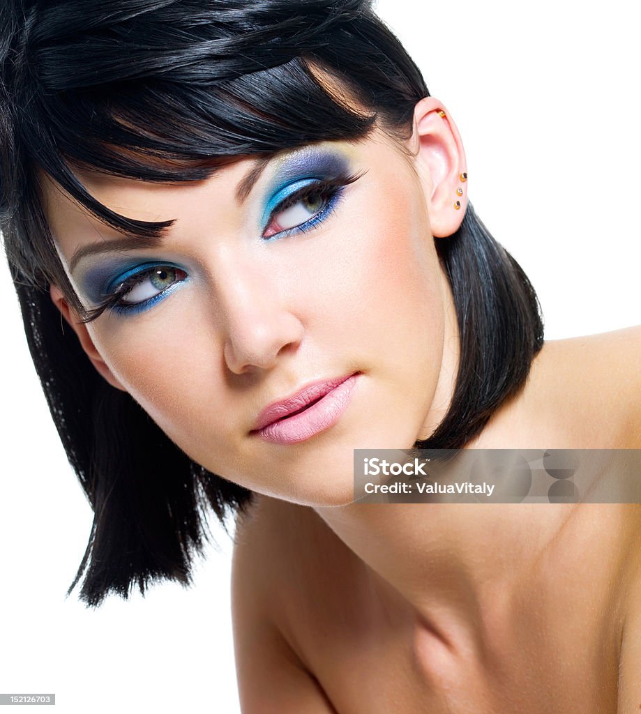 Face of a beautiful woman with blue make-up Face of a beautiful young woman with brightly blue make-up. Isolated on white Adult Stock Photo