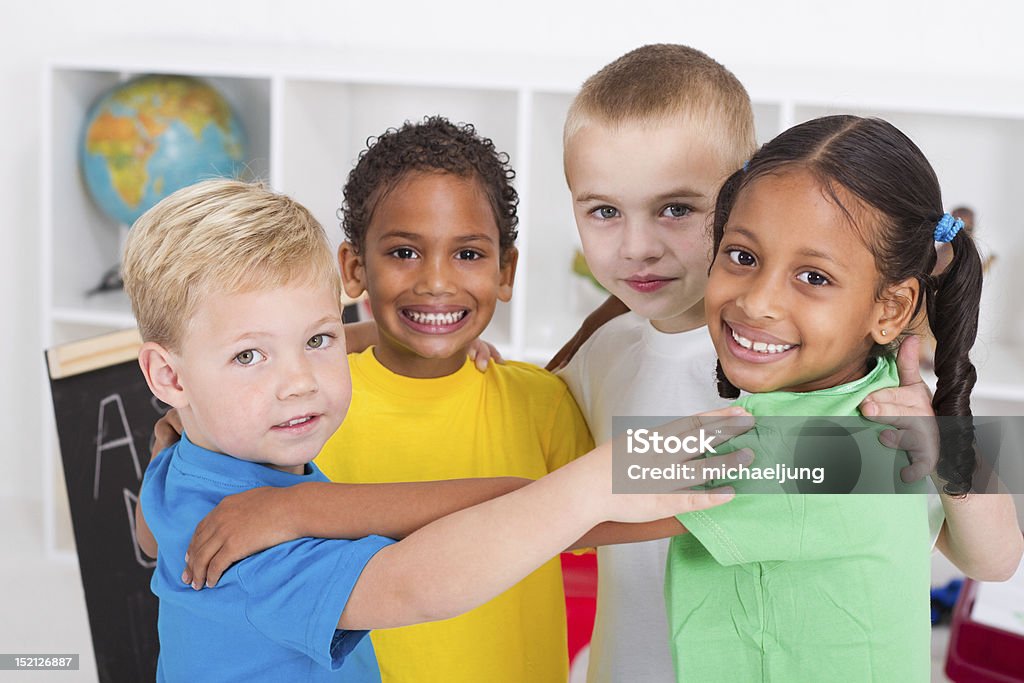 happy preschool kids hugging group of happy preschool kids hugging in classroom Preschool Stock Photo