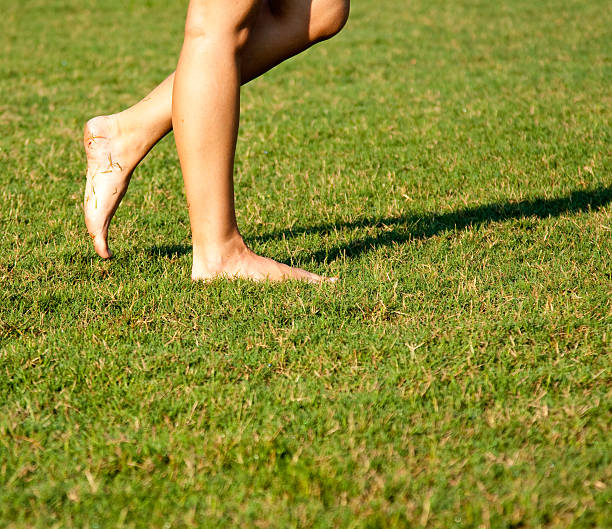 women walking barefoot stock photo