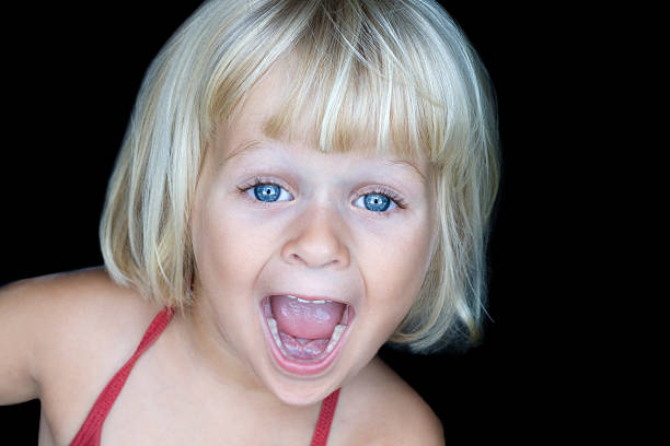 Little girl doing a funny face stock photo