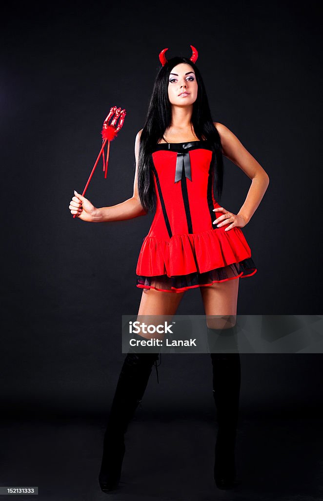 imp sexy brunette girl wearing a halloween costume of an imp Adult Stock Photo