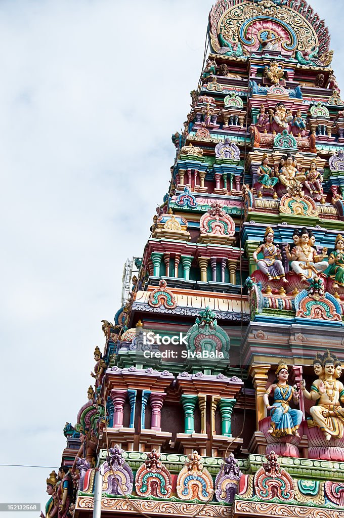 Hindu Temple Tower Gopurams are towers found at the entrances gates of Hindu Temples. Above the entrance gate these towers rise up in multiple levels tapered towards the top. Sculptures depicting various religious stories embellish the towers These include Goods and Goddesses, Humans, animals,  birds and other objects. Culture of India Stock Photo