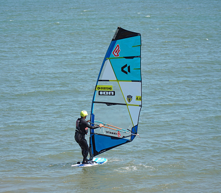 Felixstowe, Suffolk, England - June 14, 2023: Windsurfer on the sea turning