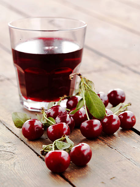 istock Cherries in original and liquid form set on a wooden table 152133902