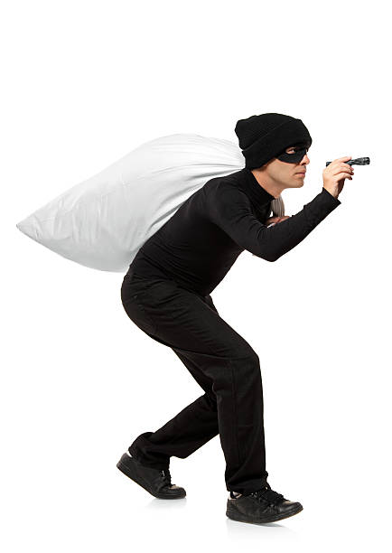 istock Thief carrying bag and holding a torch 152134009