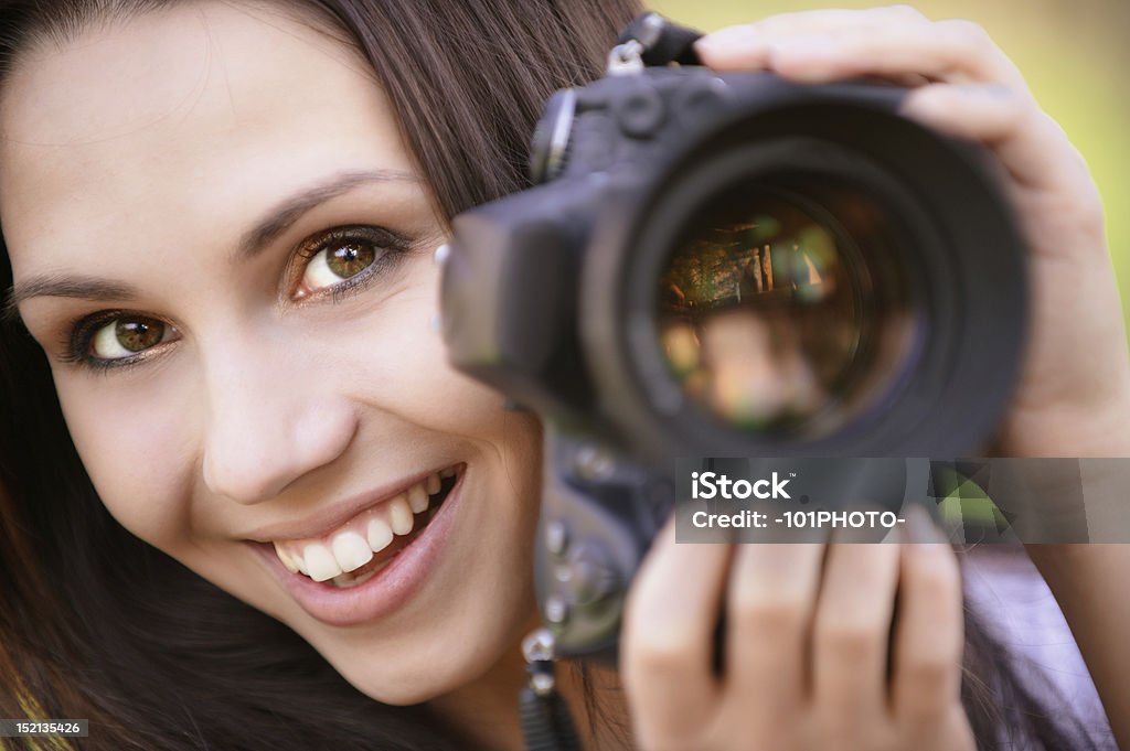 Beautiful girl with camera Beautiful smiling girl with camera on nature. Adult Stock Photo