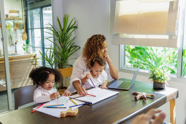 istock African mother multitasking painting with child while work from home 1521355433