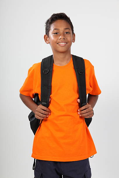 Smiling young boy 11 with rucksack ready for school