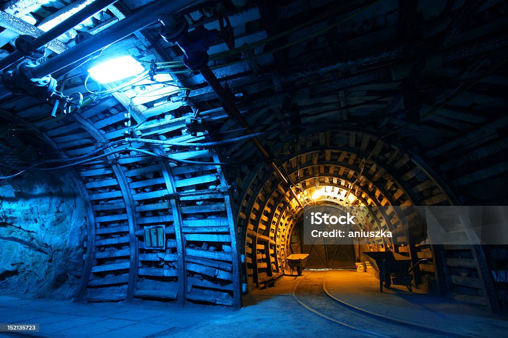 Blue and gold lit interior of a coal mine with tracks Old coal mine in Poland Black Color Stock Photo