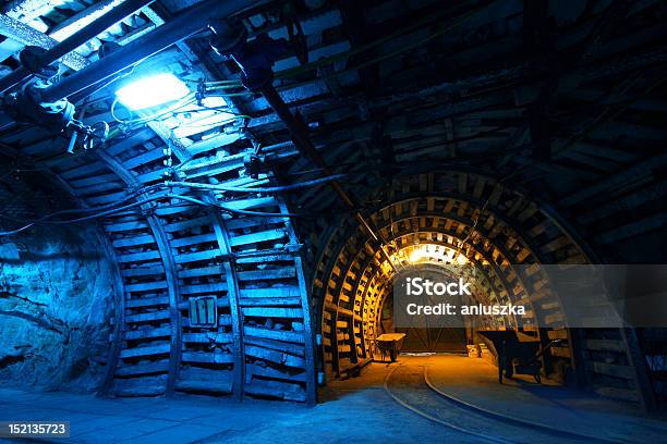 Blue And Gold Lit Interior Of A Coal Mine With Tracks Stock Photo - Download Image Now