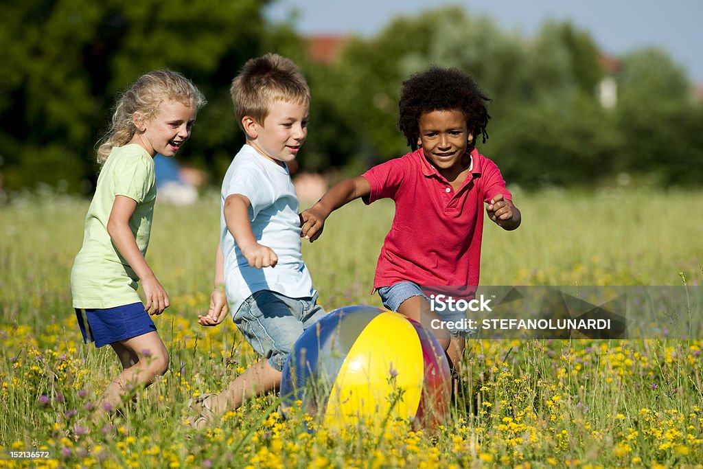 Children Playing Ball Multi-ethnic children playing ball Child Stock Photo