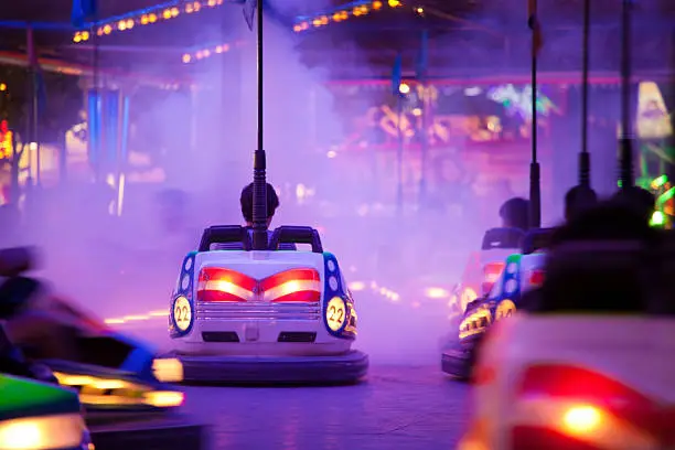 Unrecognizable people driving through artificial smoke. Soft focus and motion blur on cars. EOS 5DMII