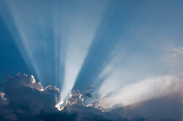 Clouds and sunbeams stock photo