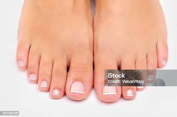 Beautiful Female Feet With French Pedicure Closeup Stock Photo - Download Image Now - Beauty, Pedicure, White Background