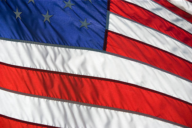 American flag flying proudly on a windy day stock photo