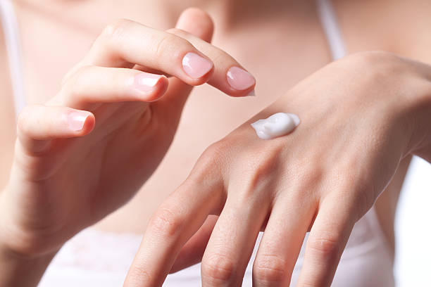 istock Woman applying a cream to her hand 152138714