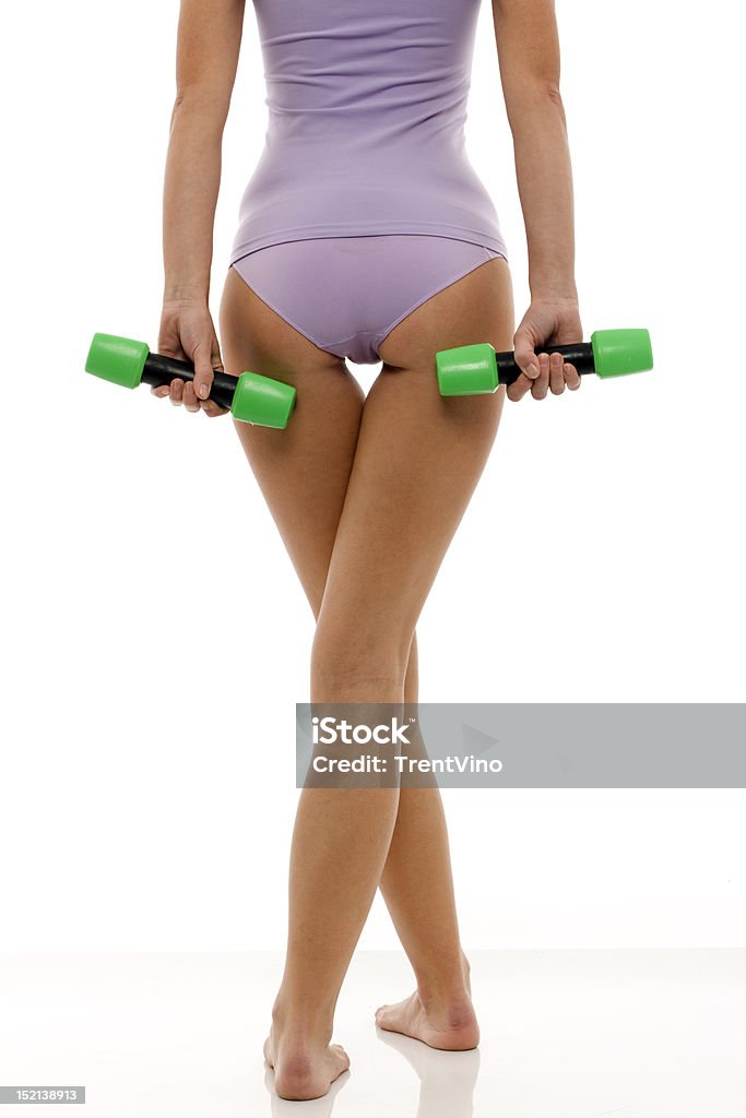 woman back with dumbbells in hand legs of a young caucasian woman in lingerie back with dumbbells in hand 20-29 Years Stock Photo
