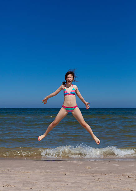 istock Girl jumping on beach 152138936