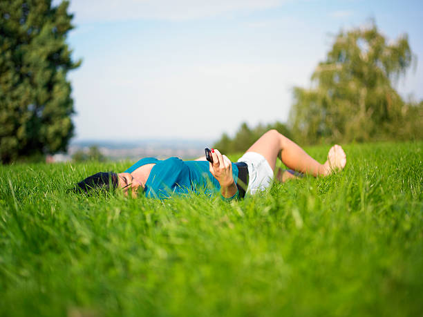 istock Young woman using mobile phone in park 152139023