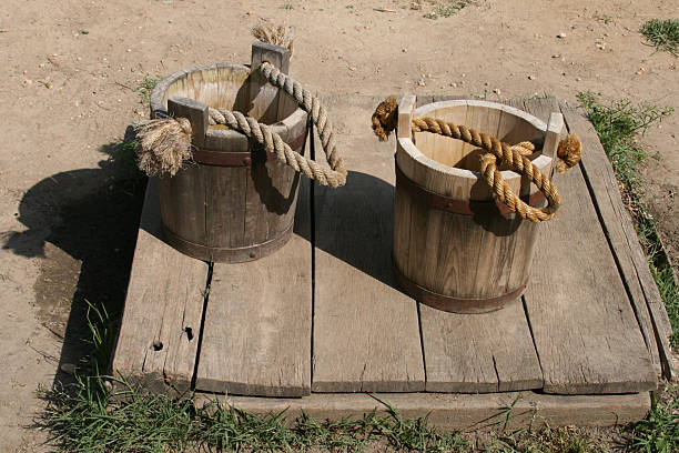 Old buckets Two empty wooden buckets standing on the ground trishz stock pictures, royalty-free photos & images