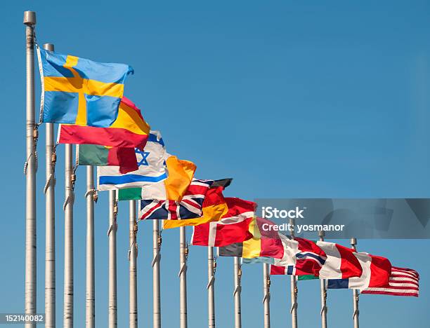 Foto de Bandeiras Multinacionais Voando Contra O Céu Azul e mais fotos de stock de Bandeira nacional - Bandeira nacional, Alemanha, Argélia